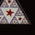 Red Star with Blue Sierpinski Triangle in Black Field